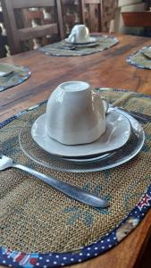 a tea pot on a plate on a table at Estresse Zero in Atins +64 photos