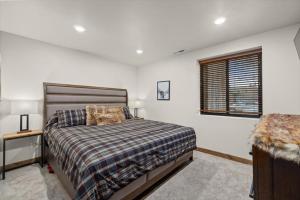a bedroom with a bed and a window at Hauser House Unit 1 Dog Friendly in Red Lodge