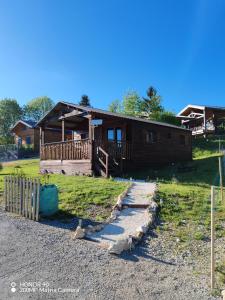 a log cabin with a path leading to it at Chalet dans le parc régional du Haut-Jura in Saint-Laurent-en-Grandvaux