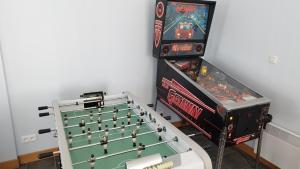 two arcade games are sitting next to each other at Le Balcon de la Pierre Claire in Villersexel +18 photos