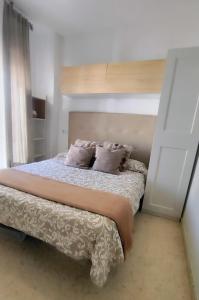 a bed with two pillows on it in a bedroom at PISO AURORA in Barbate