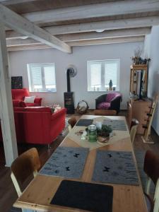 a living room with a table and a red couch at Chalupa Nad Hladinou in Teplice nad Metují