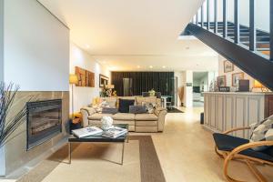 a living room with a couch and a fireplace at Host In Olivença in Vila Nova de Famalicão