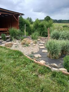 a garden with a stone path and grass at Chalupa Nad Hladinou in Teplice nad Metují