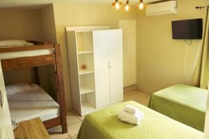 a small room with two beds and a cabinet at Hotel Andoria in San Salvador