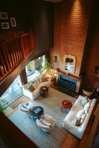 a large living room with couches and a fireplace at Casa Molino Hotel Boutique & Restaurant Puerto Varas in Puerto Varas