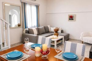 a living room with a table and a couch at Villa Oceania in Tourlos