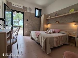 a bedroom with a bed with a teddy bear on it at Masseria Don Egidio in Melendugno