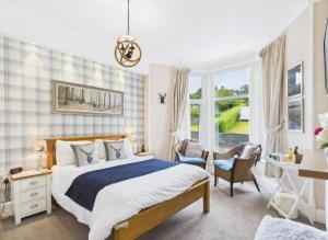 a bedroom with a bed and a desk and a window at Invergarry Room Only Guest House For Adults in Windermere
