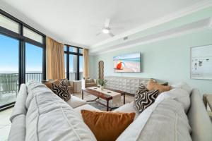a living room with a couch and a table at The Oasis 805 in Orange Beach