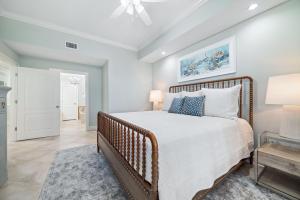 a bedroom with a bed and a ceiling fan at The Oasis 805 in Orange Beach +58 photos