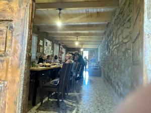 a group of people sitting at a table in a restaurant at Uplistsikhis saamo in Kʼvakhvreli