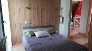 a bedroom with a bed with two pillows on it at CHALET AU CALME à GERARDMER in Gérardmer