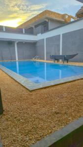 a large blue swimming pool next to a building at 7G Residency Bwejuu in Bwejuu