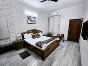 a bedroom with a bed in a room with a stone wall at Kanwar Homestay in Amritsar