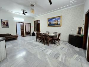 a living room with a dining room table and chairs at Kanwar Homestay in Amritsar