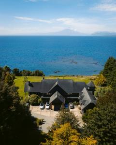 an aerial view of a house with the ocean at Casa Molino Hotel Boutique & Restaurant Puerto Varas in Puerto Varas