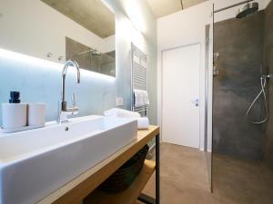 a white bathroom with a sink and a shower at Restorative stay Garden Jacuzzi Lake View in Lierna +48 photos