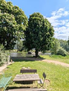 a picnic table and a bench in a park at Pirol in Niederfinow