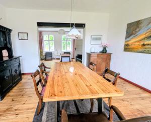 a dining room with a wooden table and chairs at Pirol in Niederfinow