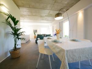 a dining room and living room with a table and chairs at Restorative stay Garden Jacuzzi Lake View in Lierna