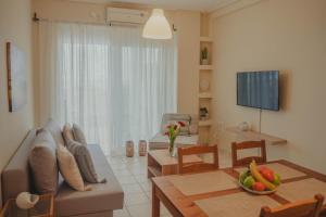 a living room with a couch and a table at Almy Sea Apartment in Karistos
