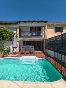 a swimming pool in front of a house at Villa Ester in Rovinj