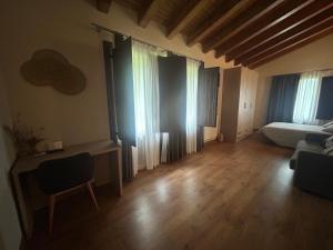 a living room with a couch and a bed at Hotel Rural Rio Molinar - ADULTS ONLY in Ranera +44 photos
