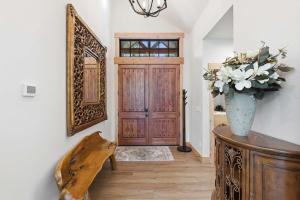 aoyer with a wooden door and a vase with flowers on a table at Serenity on 13 Suncadia-luxury 4bd ensuite spa retreat with Sauna, Steam Shower, Jacuzzi, Hot tub, Fire Pit & on-site EV chg in Cle Elum