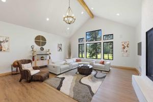 a living room with white furniture and a large window at Serenity on 13 Suncadia-luxury 4bd ensuite spa retreat with Sauna, Steam Shower, Jacuzzi, Hot tub, Fire Pit & on-site EV chg in Cle Elum +42 photos