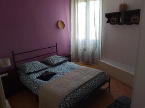 a bedroom with a bed and a window at Le café de la place in Saint-Germain-du-Teil