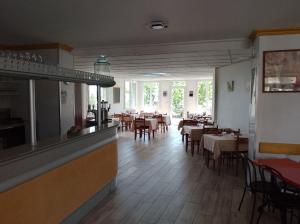 a dining room with tables and chairs in a restaurant at Le café de la place in Saint-Germain-du-Teil
