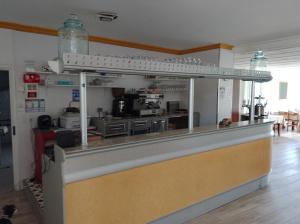 a view of a kitchen with a counter top at Le café de la place in Saint-Germain-du-Teil