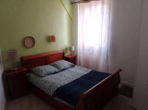a bedroom with a bed and a window at Le café de la place in Saint-Germain-du-Teil