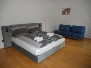 a bedroom with a bed and a blue couch at Eight in Obertraun