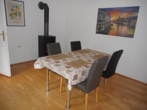a dining room table and chairs with a table and a fireplace at Eight in Obertraun