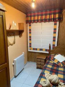 a bedroom with a bed and a window at Apartamento Berro in Guadalaviar +28 photos