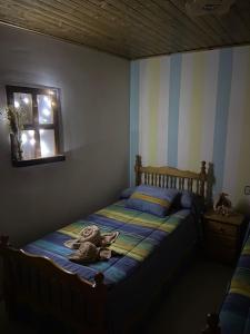 a bedroom with a bed with a hat and a window at Apartamento Berro in Guadalaviar