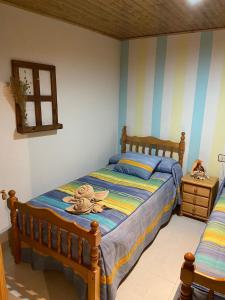 a bedroom with a bed in a room with striped walls at Apartamento Berro in Guadalaviar