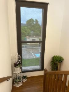 a window in a room with a bench and plants at Hotel Rural Rio Molinar - ADULTS ONLY in Ranera