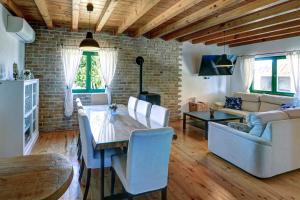 a living room with a table and a couch at Villa Stone Pearl with heated swimming pool in Sveti Filip i Jakov