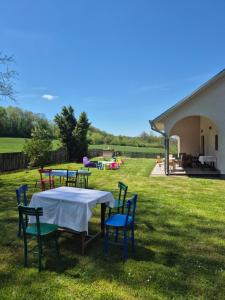 a group of tables and chairs in a yard at Kosmaj Casa Maia in Dučina