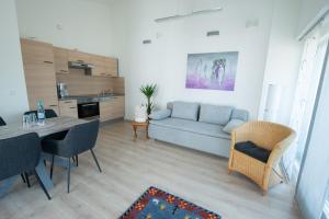 a living room with a couch and a table at Am Bienenfeld in Ettenheim