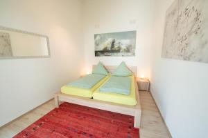 a bedroom with a bed and a red rug at Am Bienenfeld in Ettenheim