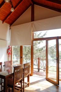 a dining room with a table and a sliding glass door at Mellmell en la Sierra in Tandil