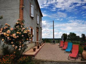 a row of chairs sitting outside of a building at Maillas D'en Haut in LʼIsle-en-Dodon