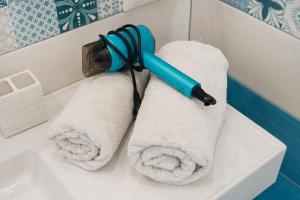 a towel dispenser sitting on top of a bathroom sink at Relais Villa Ettore in Barano d'Ischia
