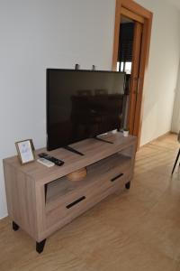 a large flat screen tv on a wooden entertainment center at Apartament Lo Passador in Deltebre