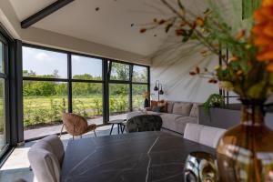 a living room with a couch and a table at De Hooiberg in Ritthem