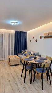 a living room with a table and a couch at SaGa Apartament in Topliţa